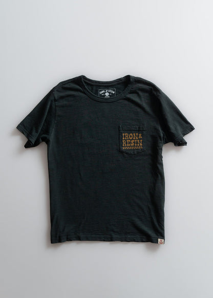 Black T-shirt with "Iron & Resin" text on chest pocket, laid flat on a light background. Simple and stylish design.