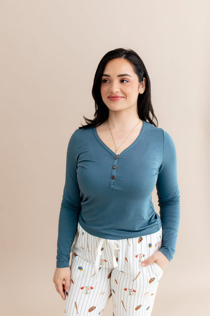 The tie drawstrings on the Women's Lounge Pants in Home Run shown on a female wearing a muted blue long sleeve henley
