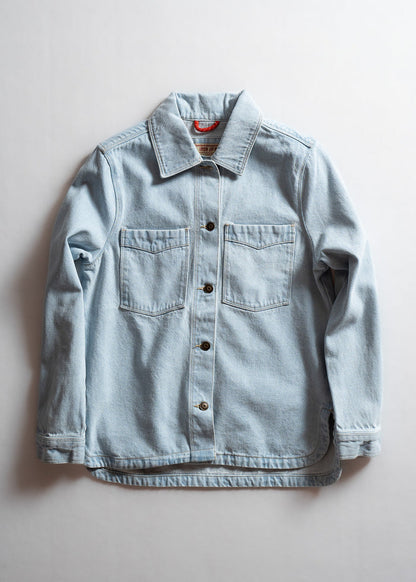 Light blue denim jacket with button closure and two chest pockets, laid flat on a white background.