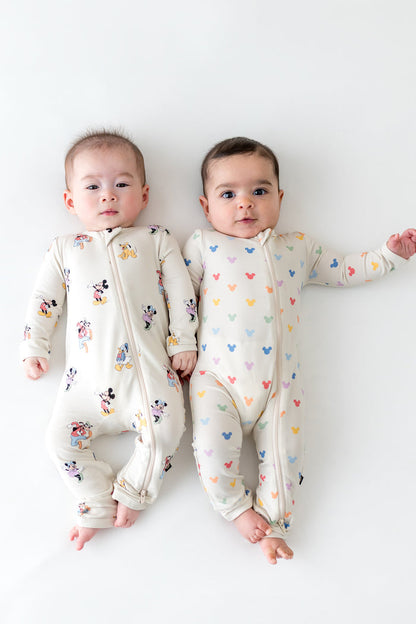2 babies wearing zippered rompers in mickey mouse patterns