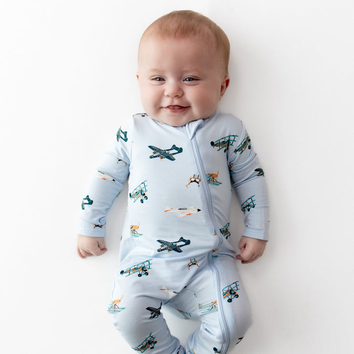 Close up of infant wearing the Zippered Romper in Take Off